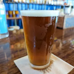 a pint of beer on a coaster