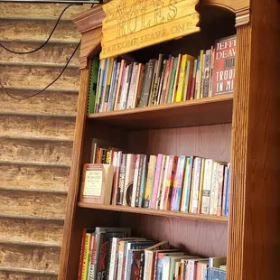 a bookshelf with a television in the background