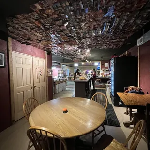 a dining room with a wooden table and chairs