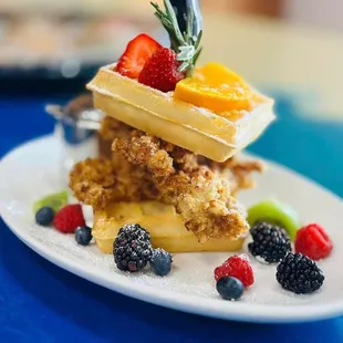 a stack of waffles with fruit on top