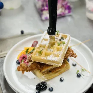 a waffle on a plate with a knife
