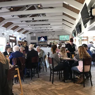 people sitting at tables in a restaurant