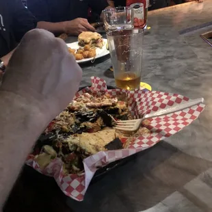 a plate of food and a glass of beer
