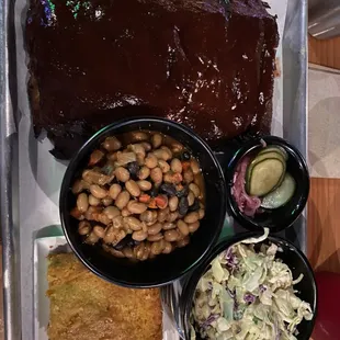 Bbq ribs with coleslaw, beans, cucumbers &amp; corn bread.