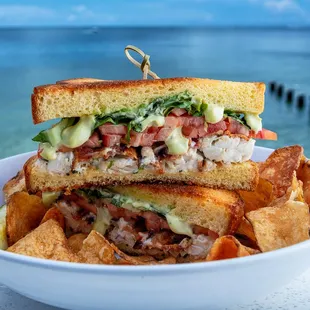 a sandwich and chips in a bowl