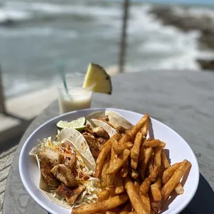 a plate of food on a table near the ocean