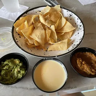 Nachos salsa guacamole and queso.