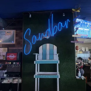 a chair and neon sign