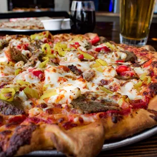 a pizza with sausage, peppers, and cheese