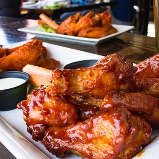 a plate of chicken wings and dipping sauce