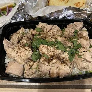 Lemon chicken with rice, curry sauce on the side.