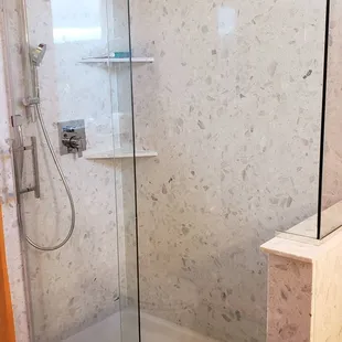 Piedrafina Bianco shower surround with custom barn shower door.