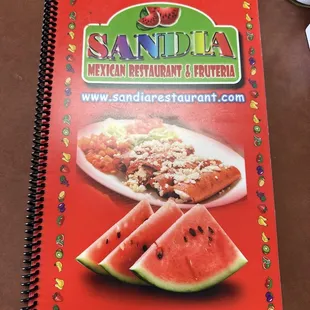 a menu and a plate of watermelon