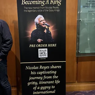 a man standing in front of a banner