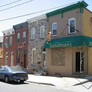 cars parked in front of a brick building