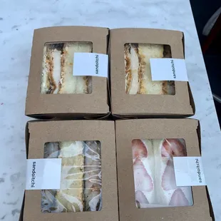 four boxes of food sitting on a table