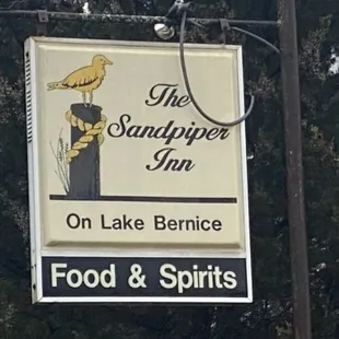 a bird perched on a sign