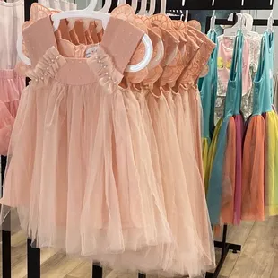 a variety of dresses on hangers