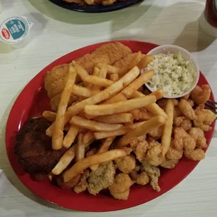 a plate of food with fries and coleslaw