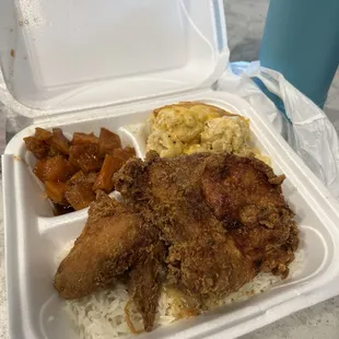 Fried chicken over rice, yams and mac and cheese