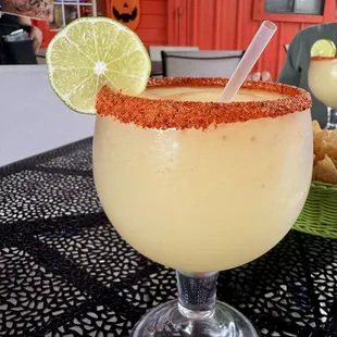 frozen margarita with tajin on the rim in the outside dining area