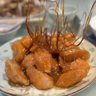 a plate of donuts covered in sauce