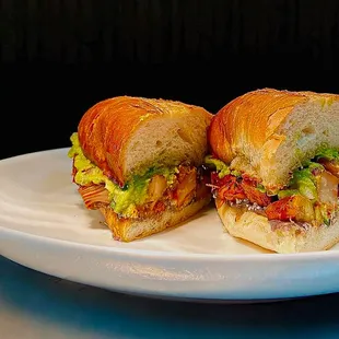 two halves of a sandwich on a plate