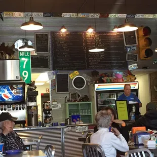 people sitting at tables in a restaurant