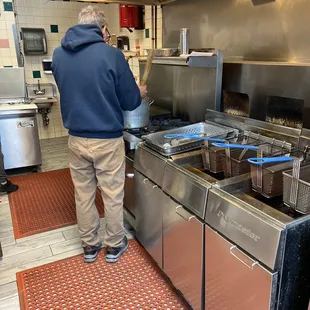 a man preparing food in a commercial kitchen