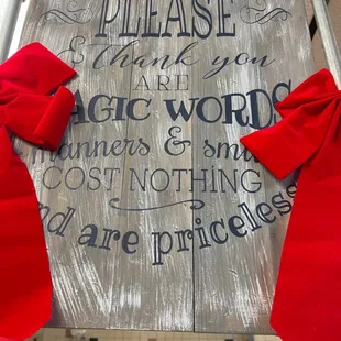 a sign with red bows on it