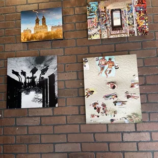 a brick wall with pictures on it