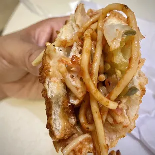 combined the spaghetti inside the chicken sandwich