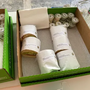 two boxes of sandwiches and a face mask