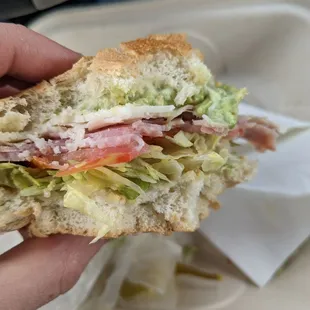 a person holding a sandwich