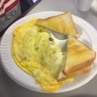 an omelet and toast on a paper plate