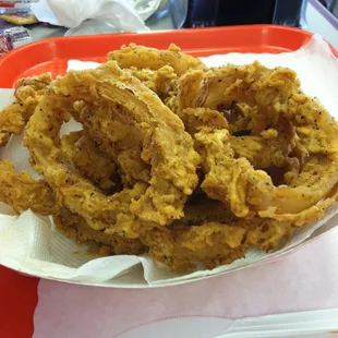 onion rings in a basket with ketchup