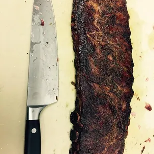 a steak on a cutting board with a knife