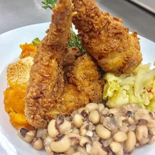 a plate of fried chicken and beans