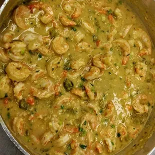 a pot of soup with shrimp and broccoli