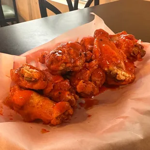 a closeup of a basket of wings