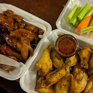 Teriyaki Wings (left) Lemon Pepper Wings (right) with two sides of Hot sauce. Veggie sticks (top) missing their Bleu Cheese counterpart.