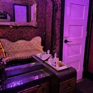 a dressing room with a mirror and a chest of drawers