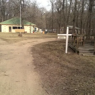 a dirt path leading to a house