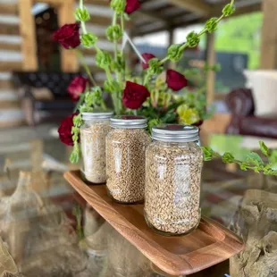 three mason jars filled with oats and flowers