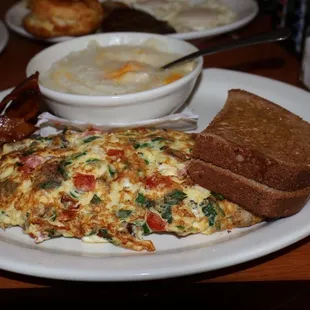 Florentine Omelette with side of bacon, cheese grits and wheat toast.