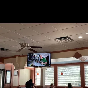 Tv and ceiling fans in main dining room area.