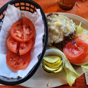 Black and Blue Burger with Cajun seasoned fresh ground round with crumbled bleu cheese,   tomatoes