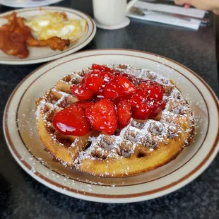 Belgian waffle with a side of eggs and bacon.