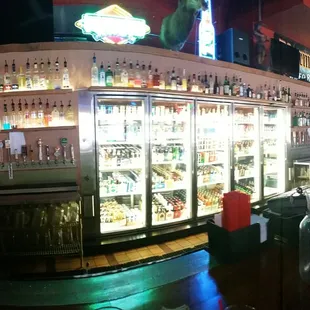 a view of a bar with many bottles of liquor
