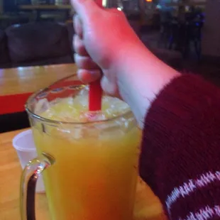 a person stirring up a drink